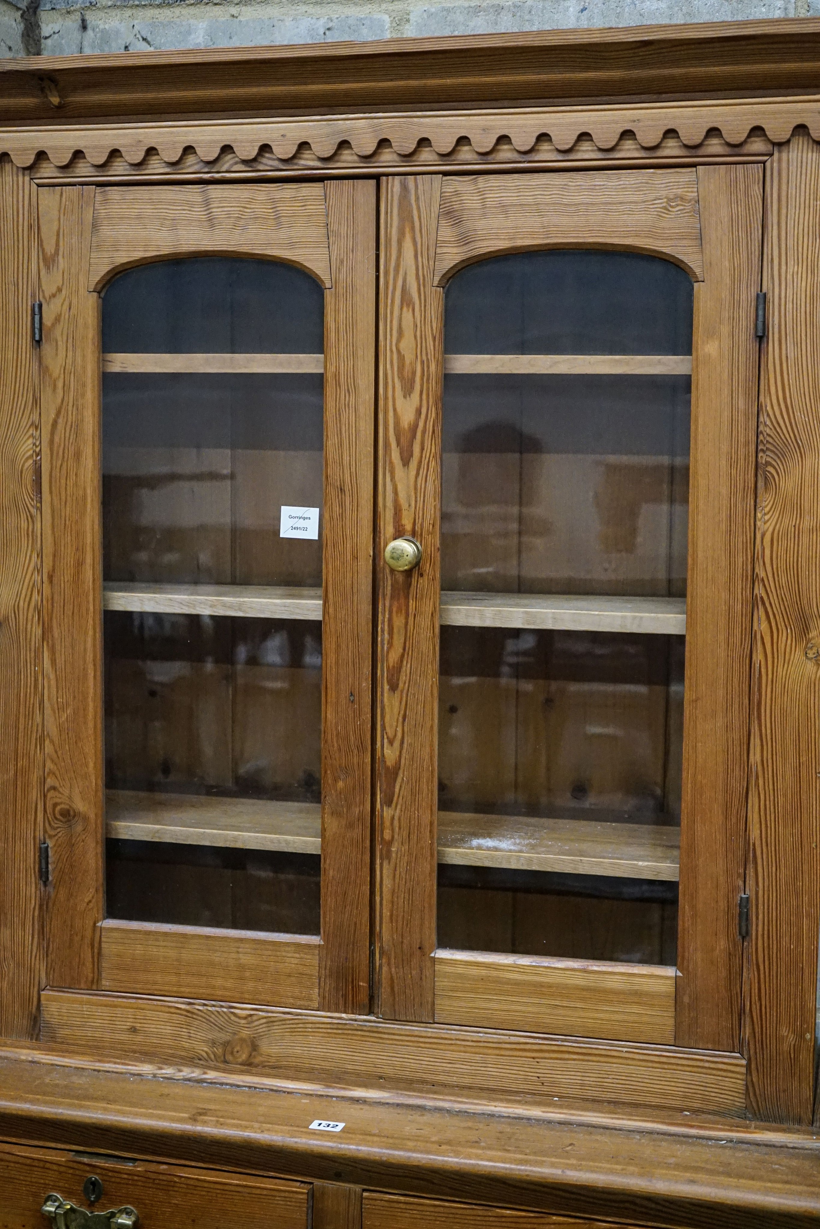 An Edwardian pine dresser, with two glazed doors over two drawers and panelled doors, width 107cm, depth 43cm, height 194cm